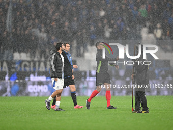 Referee Paride Tremolada tests the football field with captain Rafael Toloi (Atalanta) and Patrick Cutrone (Como) before the Italian Serie A...