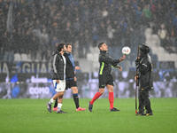 Referee Paride Tremolada tests the football field with captain Rafael Toloi (Atalanta) and Patrick Cutrone (Como) before the Italian Serie A...