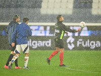 Referee Paride Tremolada tests the football field with captain Rafael Toloi (Atalanta) and Patrick Cutrone (Como) before the Italian Serie A...