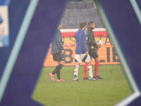 Referee Paride Tremolada tests the football field with captain Rafael Toloi (Atalanta) and Patrick Cutrone (Como) before the Italian Serie A...