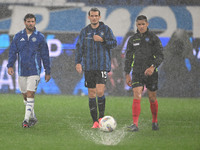 Referee Paride Tremolada tests the football field with captain Rafael Toloi (Atalanta) and Patrick Cutrone (Como) before the Italian Serie A...