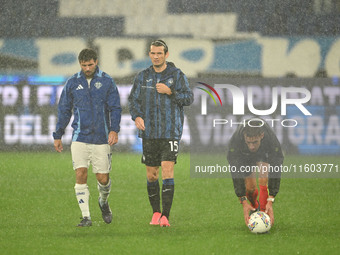 Referee Paride Tremolada tests the football field with captain Rafael Toloi (Atalanta) and Patrick Cutrone (Como) before the Italian Serie A...