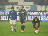 Referee Paride Tremolada tests the football field with captain Rafael Toloi (Atalanta) and Patrick Cutrone (Como) before the Italian Serie A...