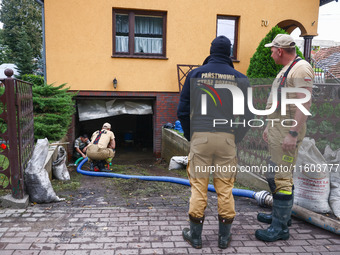 Firefighters are helping to pump out water from residential area after Nysa Klodzka river flooded town of Lewin Brzeski in southwestern Pola...