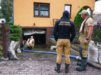 Firefighters are helping to pump out water from residential area after Nysa Klodzka river flooded town of Lewin Brzeski in southwestern Pola...