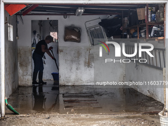 A woman is cleaning a facility which was damaged by water after Nysa Klodzka river flooded town of Lewin Brzeski in southwestern Poland. Sep...