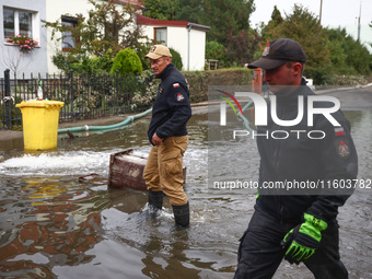 Firefighters are pumping out water from residential areas after Nysa Klodzka river flooded town of Lewin Brzeski in southwestern Poland. Sep...