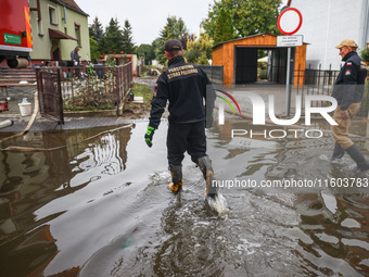 Firefighters are pumping out water from residential areas after Nysa Klodzka river flooded town of Lewin Brzeski in southwestern Poland. Sep...