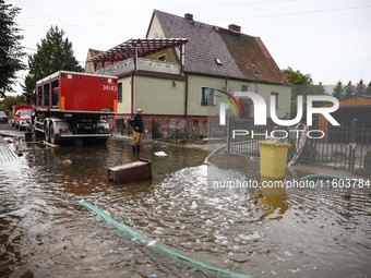 Firefighters are pumping out water from residential areas after Nysa Klodzka river flooded town of Lewin Brzeski in southwestern Poland. Sep...