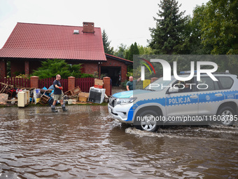 People are cleaning their houses which were damaged by water after Nysa Klodzka river flooded town of Lewin Brzeski in southwestern Poland....