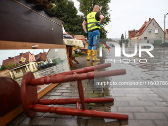 House items that were damaged by water are seen outside residential area after Nysa Klodzka river flooded town of Lewin Brzeski in southwest...