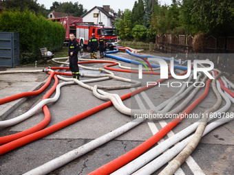 Firefighters are pumping out water from residential areas after Nysa Klodzka river flooded town of Lewin Brzeski in southwestern Poland. Sep...