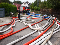 Firefighters are pumping out water from residential areas after Nysa Klodzka river flooded town of Lewin Brzeski in southwestern Poland. Sep...