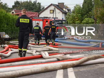 Firefighters are pumping out water from residential areas after Nysa Klodzka river flooded town of Lewin Brzeski in southwestern Poland. Sep...