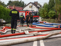 Firefighters are pumping out water from residential areas after Nysa Klodzka river flooded town of Lewin Brzeski in southwestern Poland. Sep...