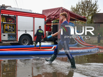 Firefighters are pumping out water from residential areas after Nysa Klodzka river flooded town of Lewin Brzeski in southwestern Poland. Sep...