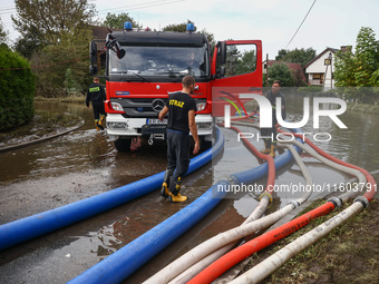 Firefighters are pumping out water from residential areas after Nysa Klodzka river flooded town of Lewin Brzeski in southwestern Poland. Sep...