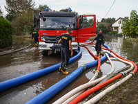 Firefighters are pumping out water from residential areas after Nysa Klodzka river flooded town of Lewin Brzeski in southwestern Poland. Sep...