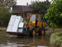 A digger is cleaning residential area which was damaged by water after Nysa Klodzka river flooded town of Lewin Brzeski in southwestern Pola...