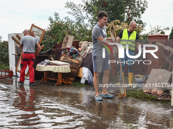 People are cleaning a house which was damaged by water after Nysa Klodzka river flooded town of Lewin Brzeski in southwestern Poland. Septem...