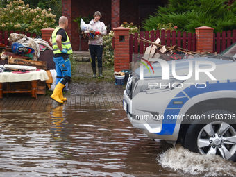 People are cleaning a house which was damaged by water after Nysa Klodzka river flooded town of Lewin Brzeski in southwestern Poland. Septem...