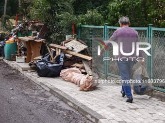 A man is cleaning a house which was damaged by water after Nysa Klodzka river flooded town of Lewin Brzeski in southwestern Poland. Septembe...