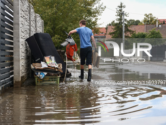 A man is cleaning a house which was damaged by water after Nysa Klodzka river flooded town of Lewin Brzeski in southwestern Poland. Septembe...