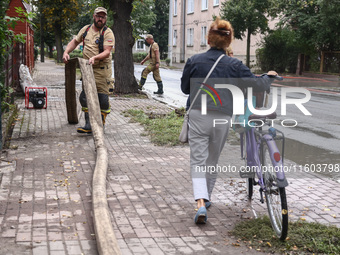 Firefighters are pumping out water from residential areas after Nysa Klodzka river flooded town of Lewin Brzeski in southwestern Poland. Sep...