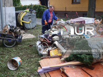 A man is cleaning a house which was damaged by water after Nysa Klodzka river flooded town of Lewin Brzeski in southwestern Poland. Septembe...