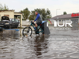 A man rides a bicycle in the water after Nysa Klodzka river flooded town of Lewin Brzeski in southwestern Poland. September 23rd, 2024. Stor...