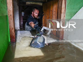 A man is cleaning a  basement which was damaged by water after Nysa Klodzka river flooded town of Lewin Brzeski in southwestern Poland. Sept...