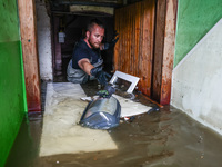 A man is cleaning a  basement which was damaged by water after Nysa Klodzka river flooded town of Lewin Brzeski in southwestern Poland. Sept...