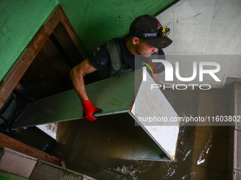 A man is cleaning a basement which was damaged by water after Nysa Klodzka river flooded town of Lewin Brzeski in southwestern Poland. Septe...