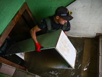 A man is cleaning a basement which was damaged by water after Nysa Klodzka river flooded town of Lewin Brzeski in southwestern Poland. Septe...