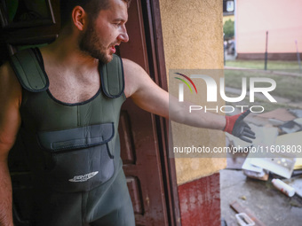 A man is cleaning a houses which was damaged by water after Nysa Klodzka river flooded town of Lewin Brzeski in southwestern Poland. Septemb...