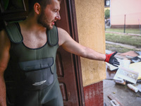 A man is cleaning a houses which was damaged by water after Nysa Klodzka river flooded town of Lewin Brzeski in southwestern Poland. Septemb...