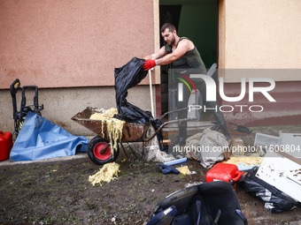 A man is cleaning a house which was damaged by water after Nysa Klodzka river flooded town of Lewin Brzeski in southwestern Poland. Septembe...