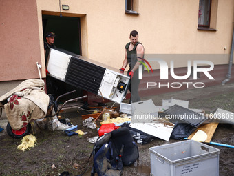 People are cleaning a house which was damaged by water after Nysa Klodzka river flooded town of Lewin Brzeski in southwestern Poland. Septem...