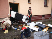 People are cleaning a house which was damaged by water after Nysa Klodzka river flooded town of Lewin Brzeski in southwestern Poland. Septem...