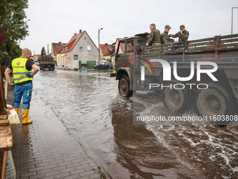 People are cleaning their houses which were damaged by water after Nysa Klodzka river flooded town of Lewin Brzeski in southwestern Poland....