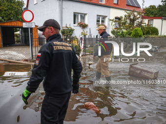 Firefighters are pumping out water from residential areas after Nysa Klodzka river flooded town of Lewin Brzeski in southwestern Poland. Sep...