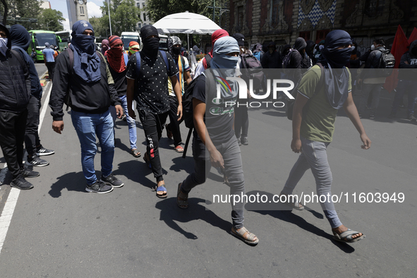 Colleagues of the 43 missing students from Ayotzinapa protest outside the Ministry of the Interior in Mexico City, Mexico, on September 23,...