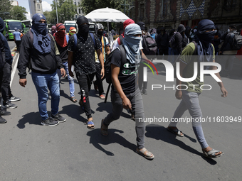 Colleagues of the 43 missing students from Ayotzinapa protest outside the Ministry of the Interior in Mexico City, Mexico, on September 23,...