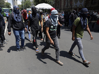 Colleagues of the 43 missing students from Ayotzinapa protest outside the Ministry of the Interior in Mexico City, Mexico, on September 23,...