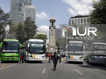 A busload of comrades of the 43 missing students from Ayotzinapa stands outside the Ministry of the Interior in Mexico City, Mexico, on Sept...