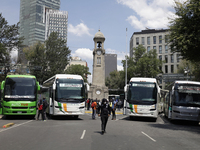 A busload of comrades of the 43 missing students from Ayotzinapa stands outside the Ministry of the Interior in Mexico City, Mexico, on Sept...