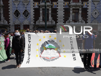 Colleagues of the 43 missing students from Ayotzinapa protest outside the Ministry of the Interior in Mexico City, Mexico, on September 23,...