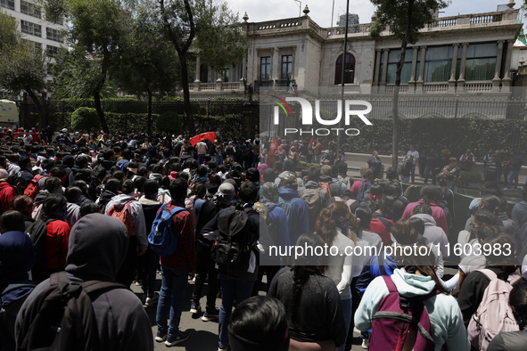 Colleagues of the 43 missing students from Ayotzinapa protest outside the Ministry of the Interior in Mexico City, Mexico, on September 23,...