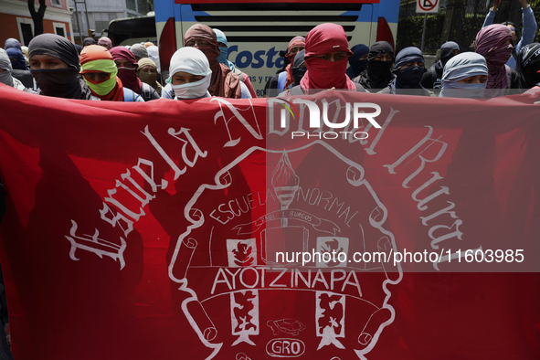 Colleagues of the 43 missing students from Ayotzinapa protest outside the Ministry of the Interior in Mexico City, Mexico, on September 23,...