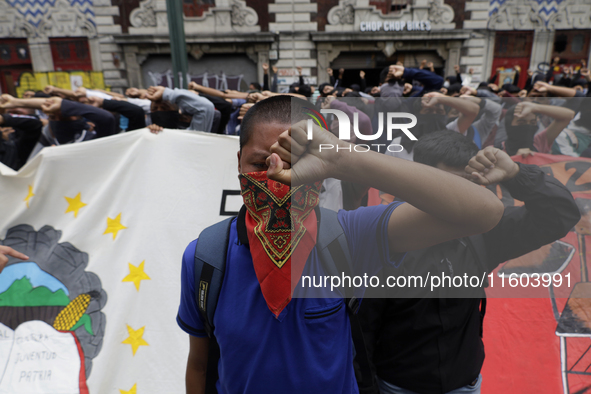 Colleagues of the 43 missing students from Ayotzinapa protest with fists raised outside the Ministry of the Interior in Mexico City, Mexico,...